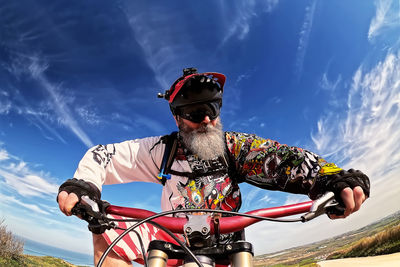 Side view of man standing against sky