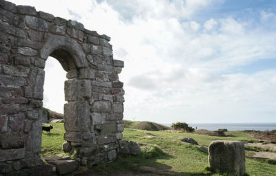 Old ruin building against cloudy sky