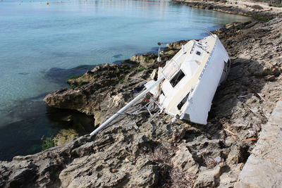 Dilapidated abandoned yacht wrecked on the coast