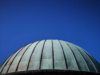 Low angle view of modern building against clear blue sky