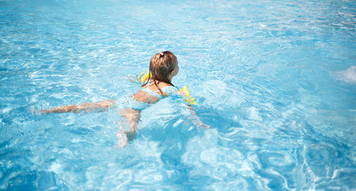 High angle view of girl swimming in pool