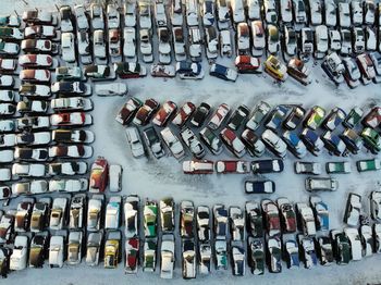 High angle view of cars parked on snowy road