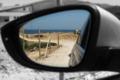 Reflection of car on side-view mirror