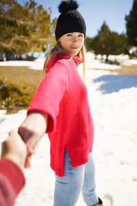 Portrait of young woman standing at beach