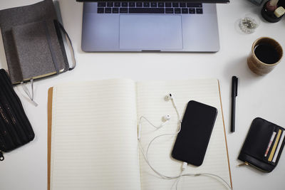 View of desk with diary and cell phone