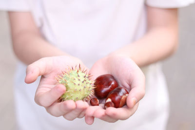 Close-up of woman holding fruit