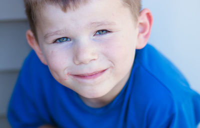 Close-up portrait of smiling boy at home