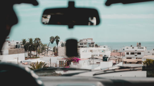 Close-up of car by sea against sky