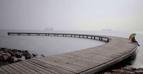 Pier over  lake against sky