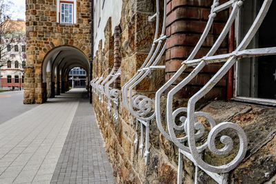 Footpath amidst buildings in city