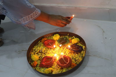 High angle view of hand holding candles