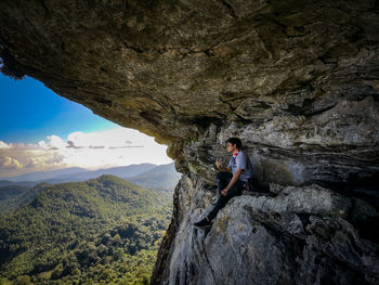 Man standing on rock against mountains