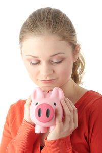 Close-up portrait of a smiling young woman over white background