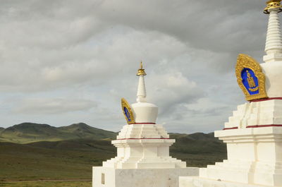 Statue of temple against cloudy sky