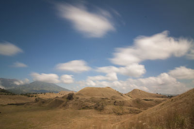 Scenic view of arid landscape against sky