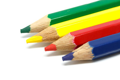 Close-up of multi colored pencils on white background