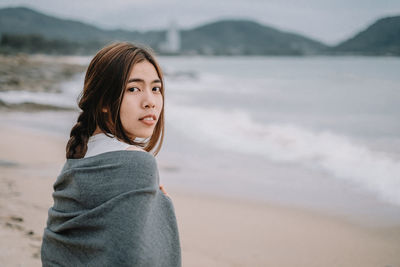 Portrait of mid adult woman standing on beach