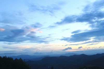 Scenic view of silhouette mountains against sky at sunset