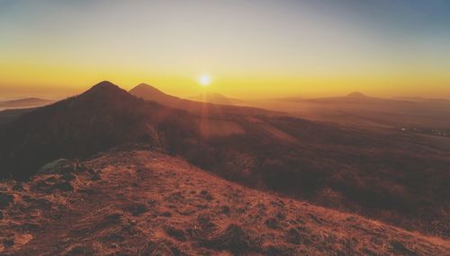 Scenic view of mountains against sky during sunset