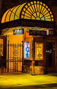 Illuminated entrance of building at night