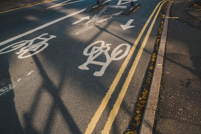 High angle view of arrow symbol on road in city