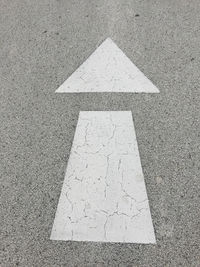 High angle view of arrow symbol on road