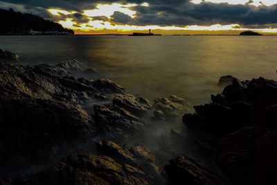 Scenic view of sea against sky at sunset