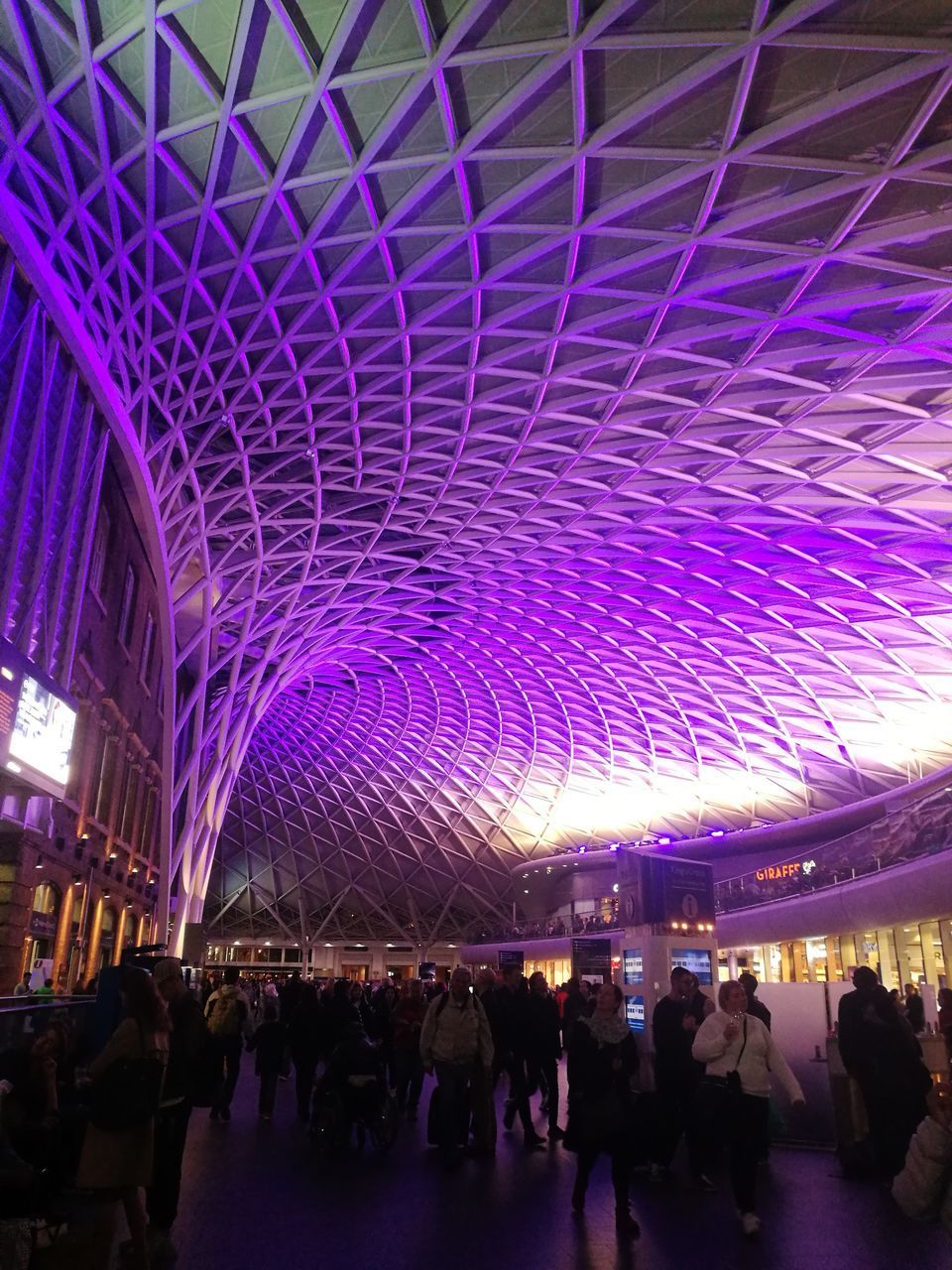 GROUP OF PEOPLE IN ILLUMINATED BUILDING