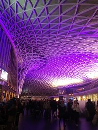 Group of people in illuminated building at night