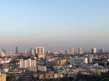 High angle view of buildings in city against clear sky