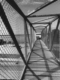View of bridge seen through chainlink fence