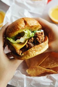 Midsection of person holding burger