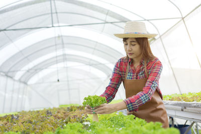 Woman standing in greenhouse