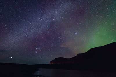 Scenic view of lake against star field at night