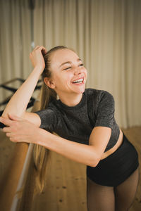 Portrait of young woman sitting at home