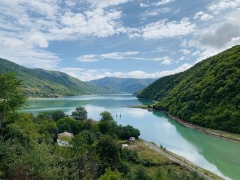 Scenic view of lake and mountains against sky