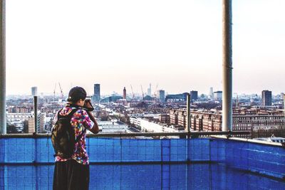 Rear view of woman standing in city