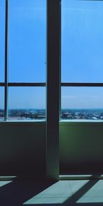 Swimming pool by sea against sky seen through window