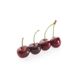 Close-up of cherries against white background