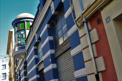 Low angle view of modern building against clear blue sky