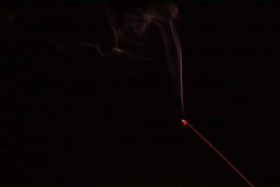 Close-up of illuminated lighting equipment against black background