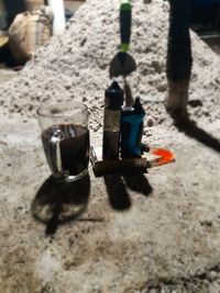 High angle view of wine glasses on sand