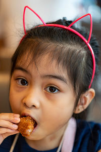 Close-up portrait of cute boy eating food