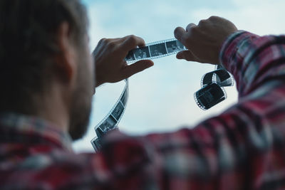 Cropped hand of man playing guitar