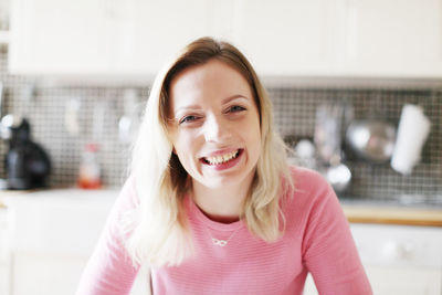 Portrait of smiling young woman at home