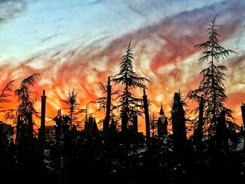 Low angle view of silhouette trees against sky at sunset