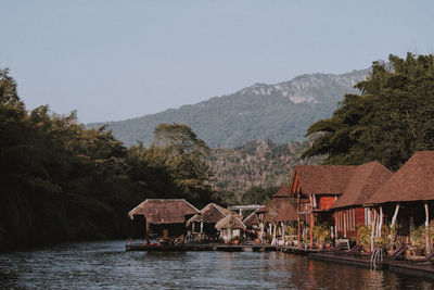 Scenic view of lake and buildings against sky