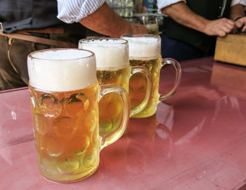 Close-up of beer glasses on table at bar