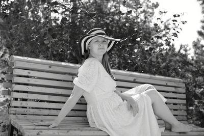 Woman sitting on bench in park