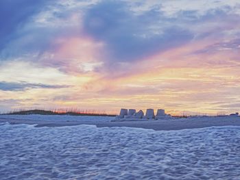 Scenic view of sea against orange sky during winter